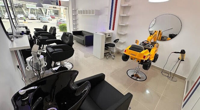 Interior of TOUCH UP - Wadi Kabir, Muscat, Oman featuring stylish salon chairs and bright decor.