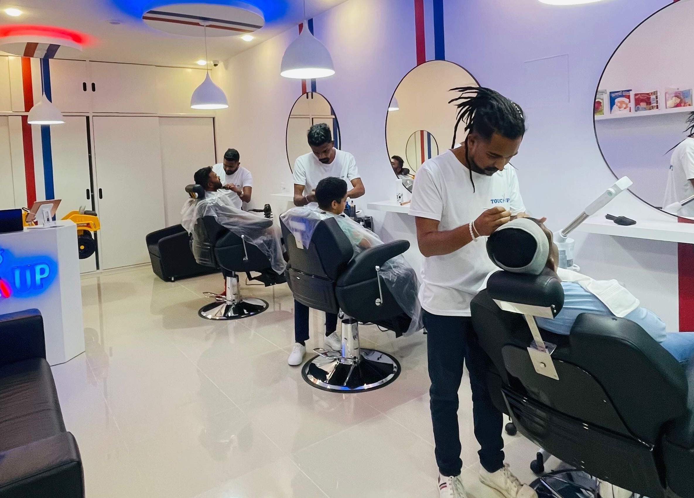 Inside TOUCH UP - Wadi Kabir, Muscat, Oman: stylish salon with professionals in action at Wadi Al Kabir, Muscat Governorate, OM.