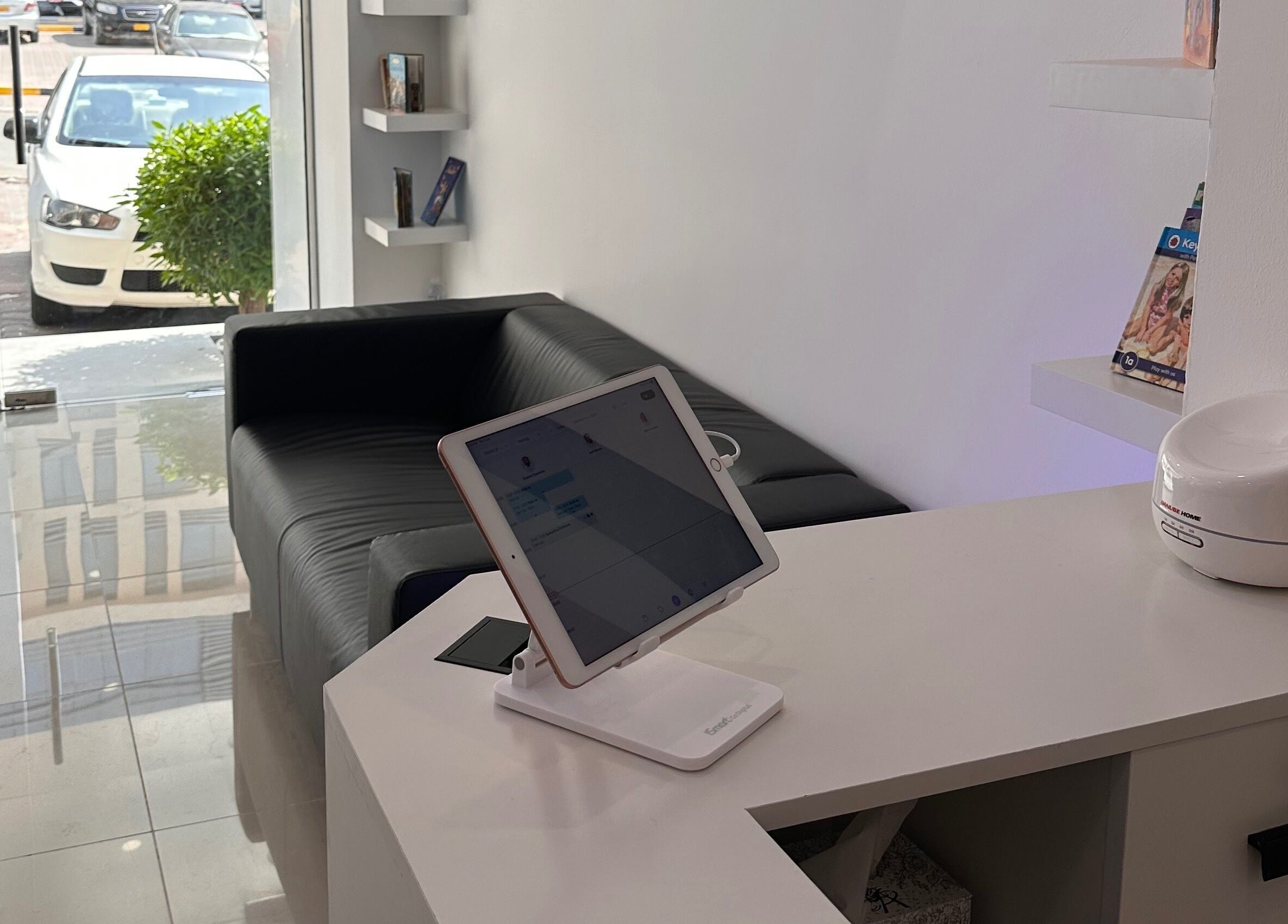 Seating area at TOUCH UP - Wadi Kabir, Muscat, Oman with black sofa and tablet at reception desk. Venue: Wadi Al Kabir, Muscat Governorate, OM.