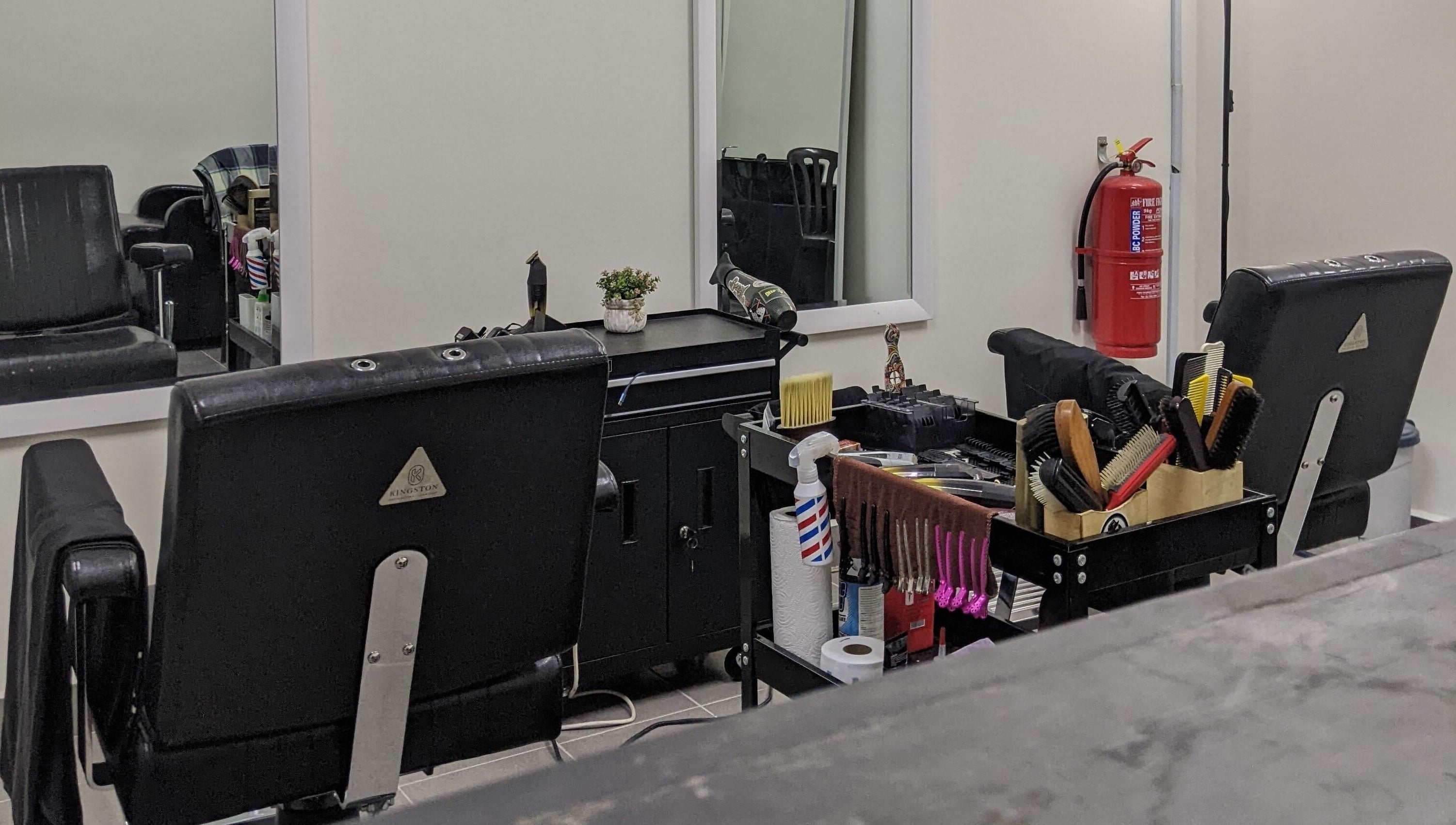 Stylish barber setup at Propercutz, Kuala Lumpur, Wilayah Persekutuan Kuala Lumpur, MY showcasing tools and chairs.