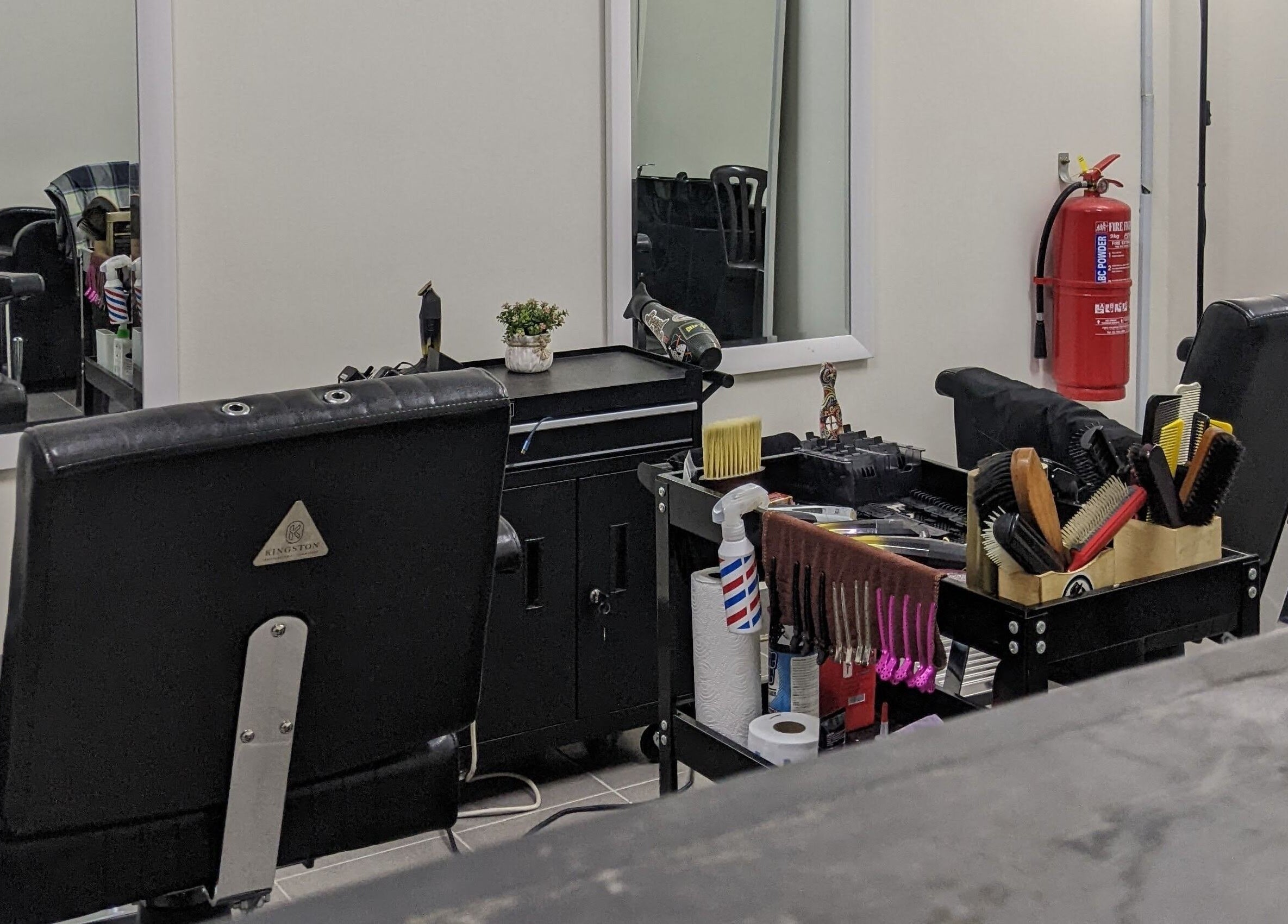 Stylish barber setup at Propercutz, Kuala Lumpur, Wilayah Persekutuan Kuala Lumpur, MY showcasing tools and chairs.
