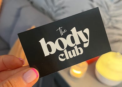 Business card for The Body Club, Lisburn, Northern Ireland, GB, held by a hand with a stylish manicure.