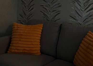 Comfortable seating area with orange cushions at The Body Club, Lisburn, Northern Ireland, GB.