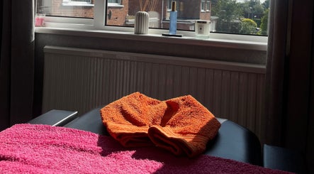 Relaxing therapy room at The Body Club, Lisburn, Northern Ireland, GB with cozy towels and serene decor.