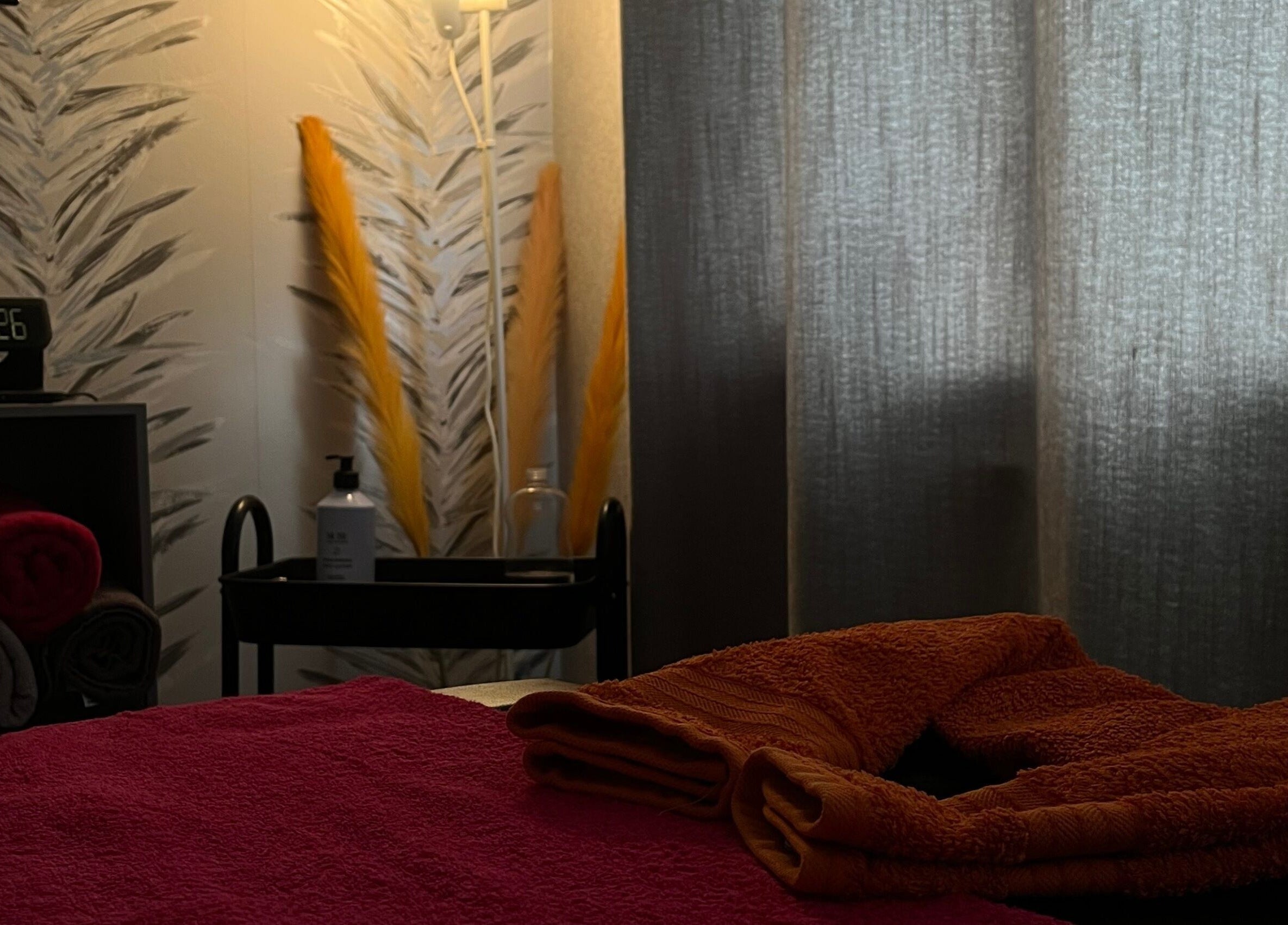 Relaxing therapy room at The Body Club, Lisburn, Northern Ireland, GB with towels and soft lighting.