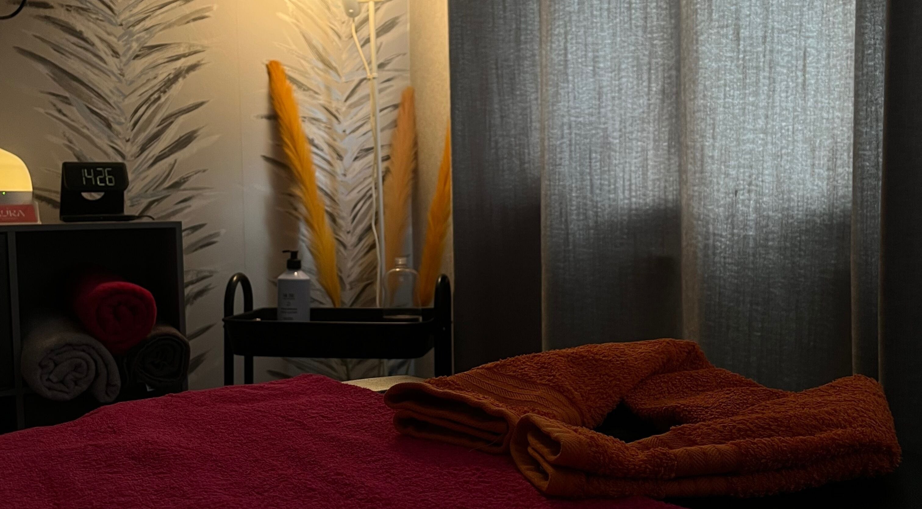Relaxing therapy room at The Body Club, Lisburn, Northern Ireland, GB with towels and soft lighting.