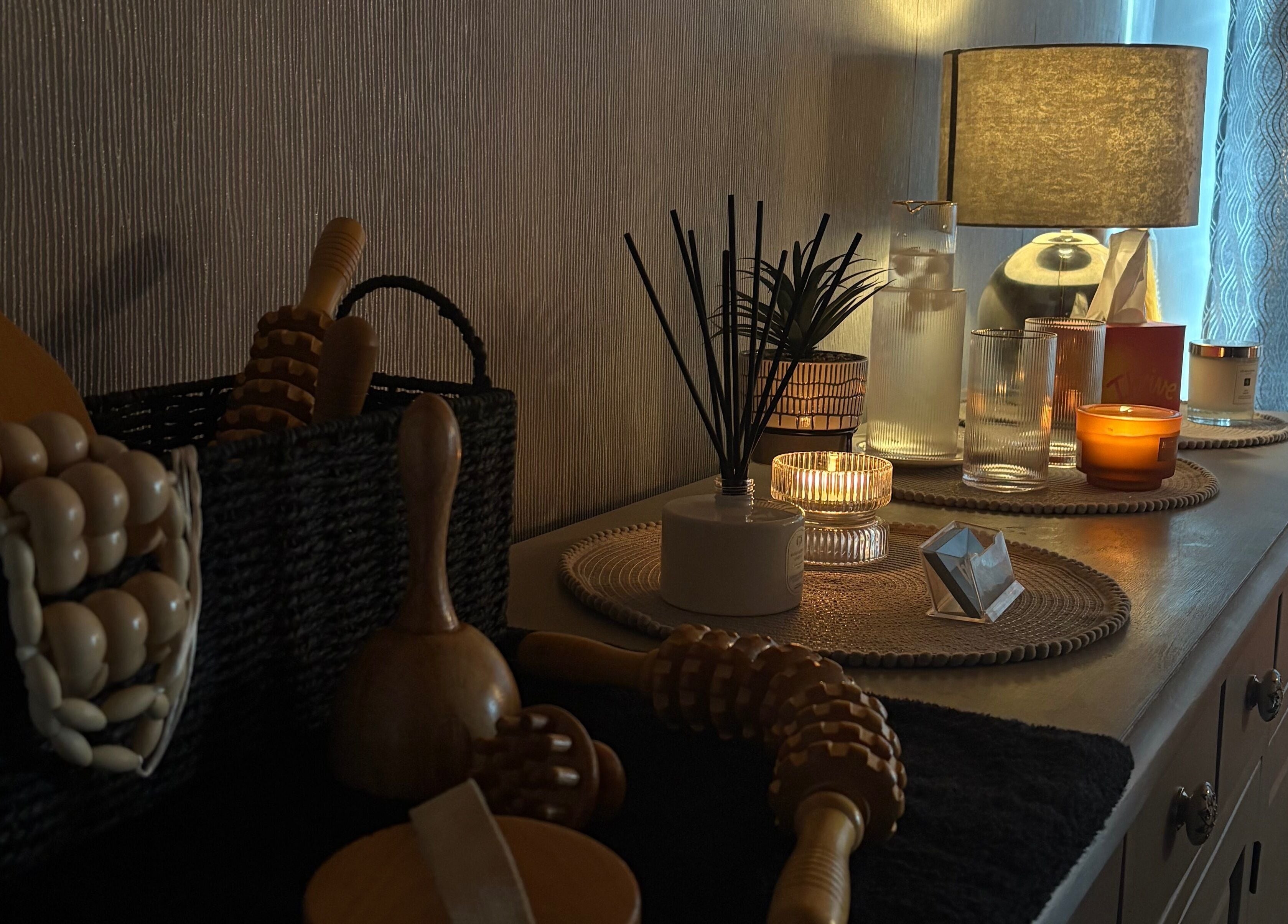 Relaxing treatment room at The Body Club, Lisburn, Northern Ireland, GB with candles and wooden rollers.