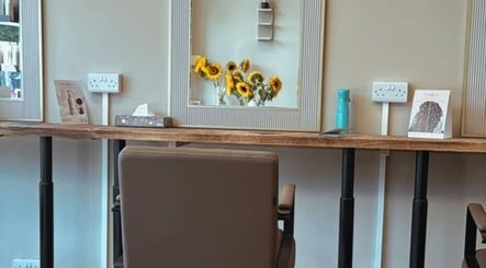 Hairdressing by Alice salon station with sunflowers in mirror, Rustington, England, GB.