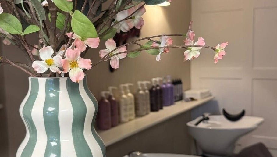 Chic vase with flowers at Hairdressing by Alice, Rustington, England, GB, enhancing salon ambiance.