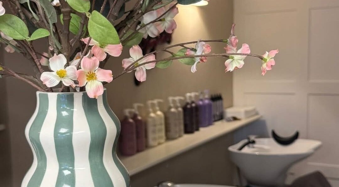 Chic vase with flowers at Hairdressing by Alice, Rustington, England, GB, enhancing salon ambiance.