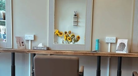 Bright styling station at Hairdressing by Alice, Rustington, England, GB, with fresh sunflowers and chic decor.