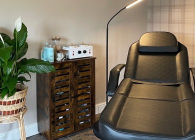 Relaxing nail treatment room at The Nail Garage, Frodsham, England, GB, featuring a black chair and plant decor.