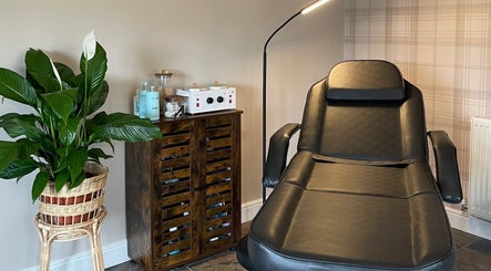 Relaxing nail treatment room at The Nail Garage, Frodsham, England, GB, featuring a black chair and plant decor.