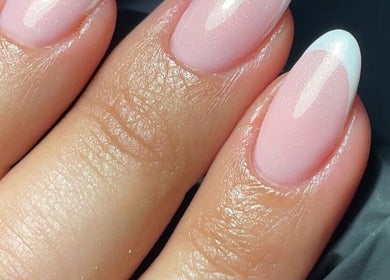 Stylish French manicure at The Nail Garage, Frodsham, England, GB. Elegant pink nails with white tips.