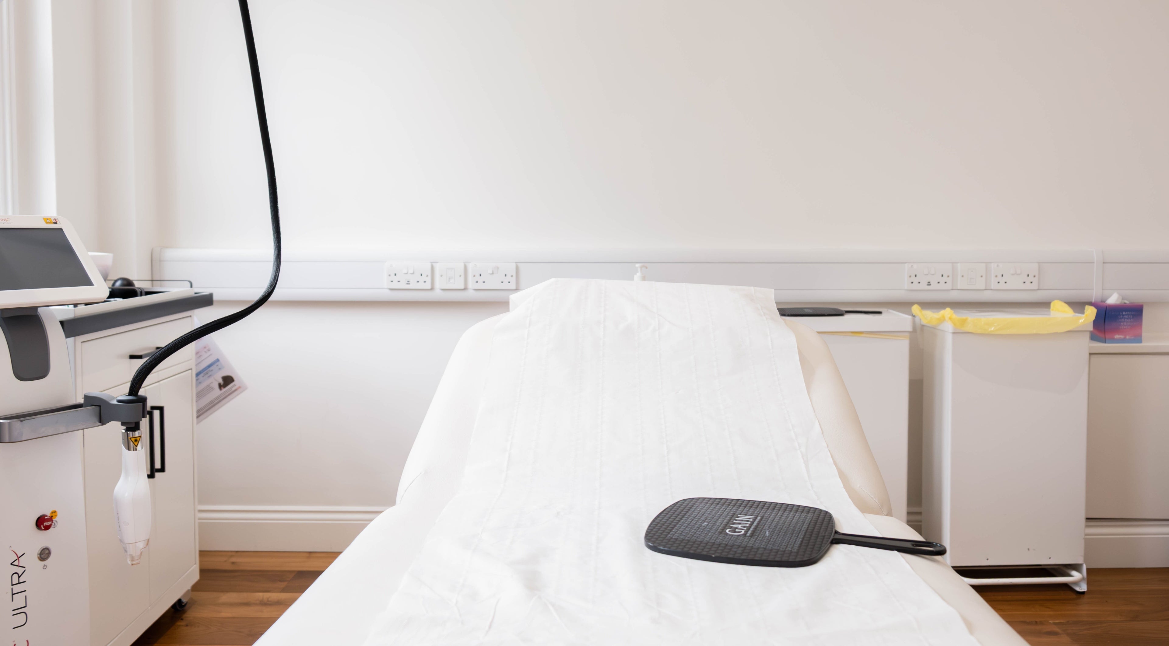 Modern treatment room at Dr Kajal Aesthetics, London, England, GB, showcasing advanced equipment and serene ambiance.