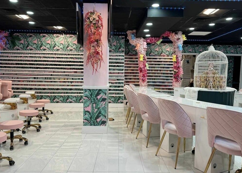Stylish interior of Pastel Nail Studio in South Boston, Massachusetts, US, featuring pink seating and floral décor.
