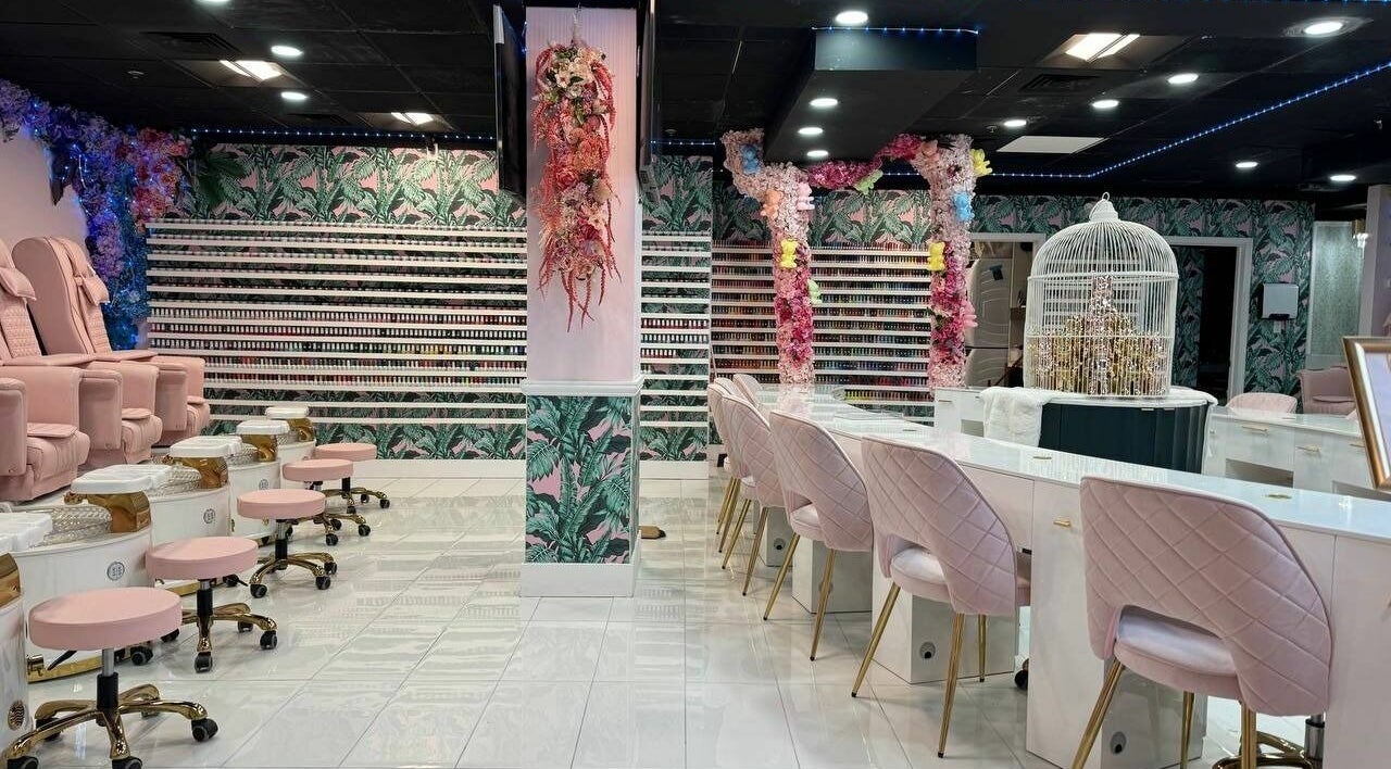 Stylish interior of Pastel Nail Studio in South Boston, Massachusetts, US, featuring pink seating and floral décor.