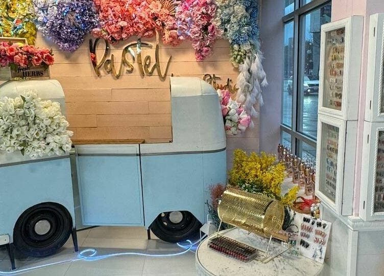 Vibrant floral interior of Pastel Nail Studio in South Boston, Massachusetts, US, showcasing colorful decor and nail designs.