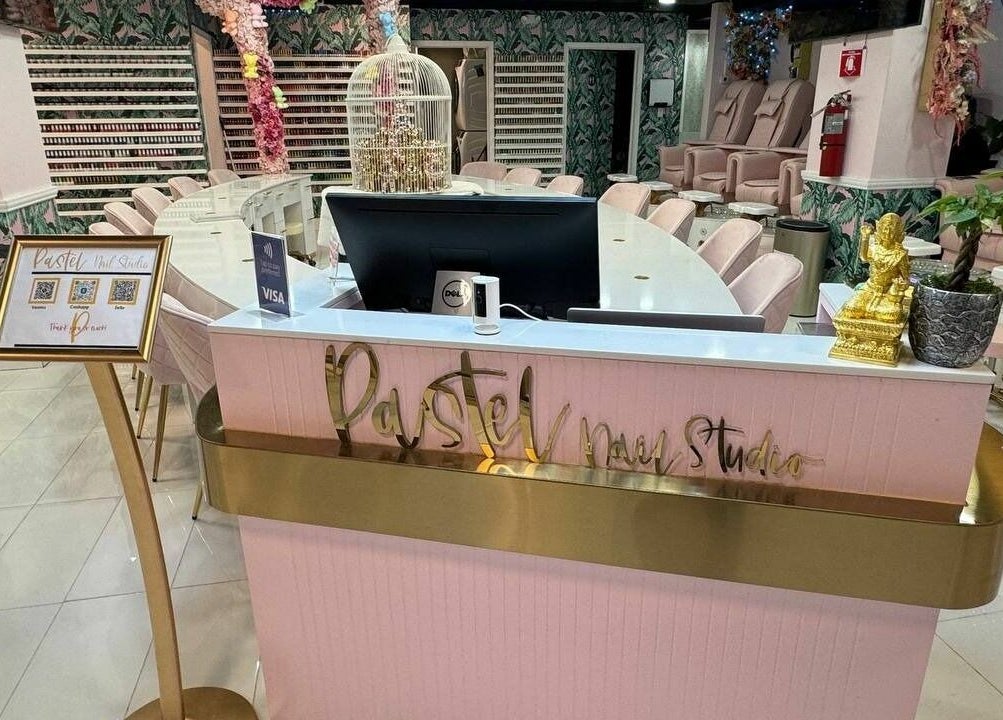 Reception at Pastel Nail Studio, South Boston, Massachusetts, US, showcasing elegant decor and seating area.