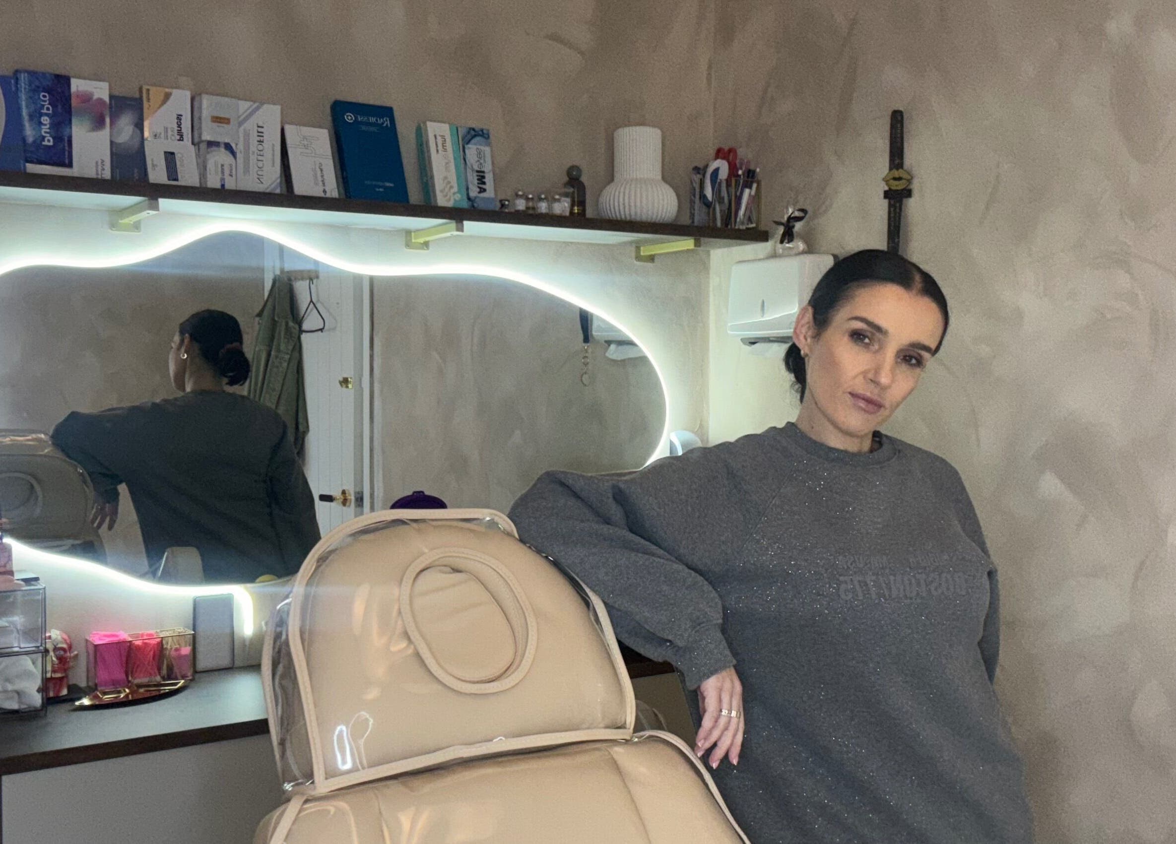 Phace Institute treatment room with neon mirror and beauty products, Belfast, Northern Ireland, GB.