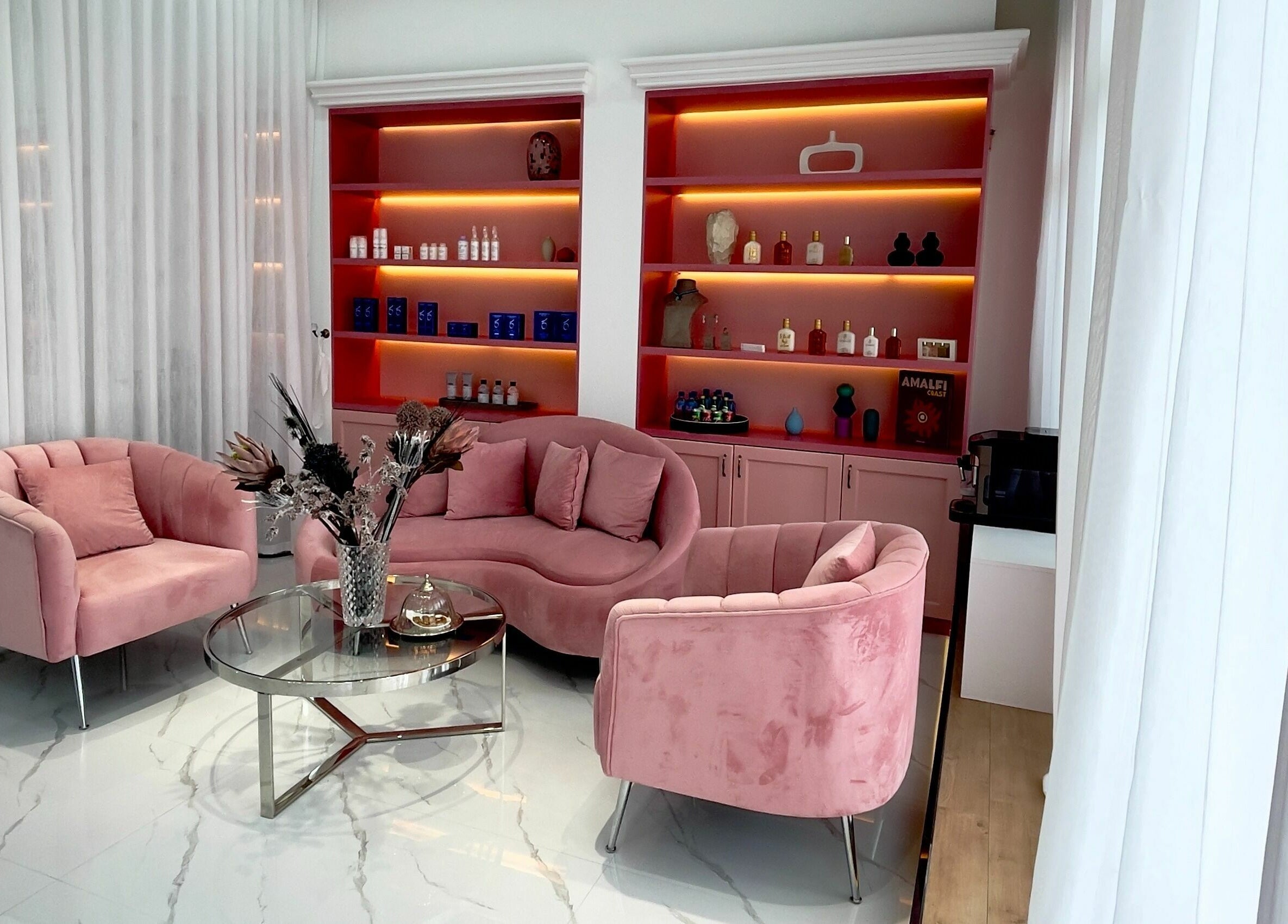 Chic pink seating area at Soarè Beauty Ladies Salon, Dubai, Dubai, AE with modern decor and soft lighting.