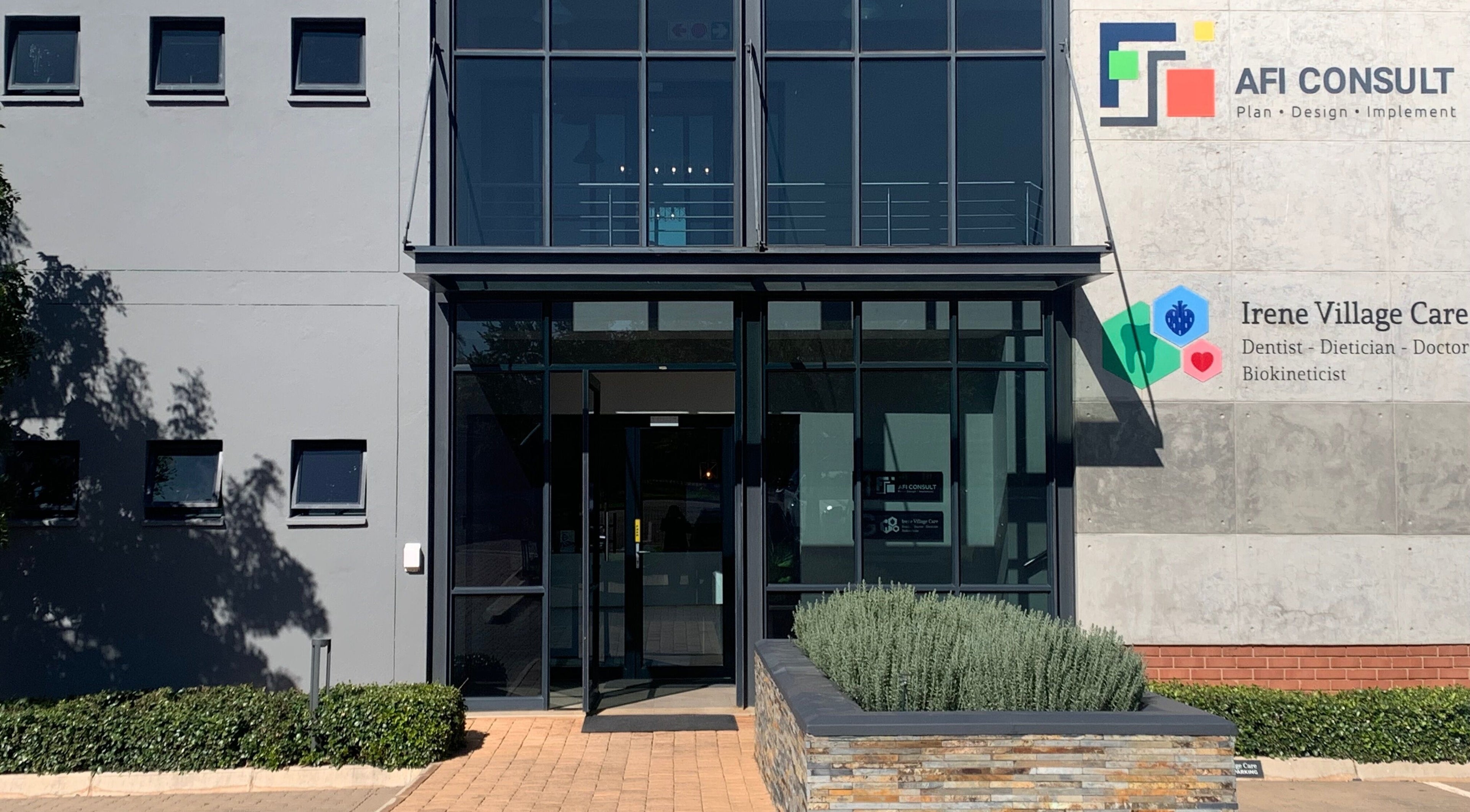 Modern building entrance of Serene Aesthetics in Centurion, Gauteng, ZA, showcasing sleek glass doors.