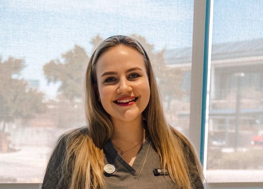 Friendly staff member at Serene Aesthetics, Centurion, Gauteng, ZA, welcoming guests with a smile.