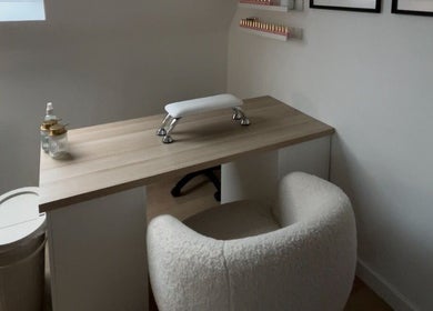 Cozy nail station at bylaceycathcart, Rosyth, Scotland, GB, featuring a plush chair and wooden table.
