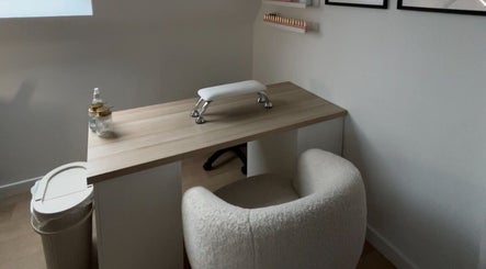Cozy nail station at bylaceycathcart, Rosyth, Scotland, GB, featuring a plush chair and wooden table.