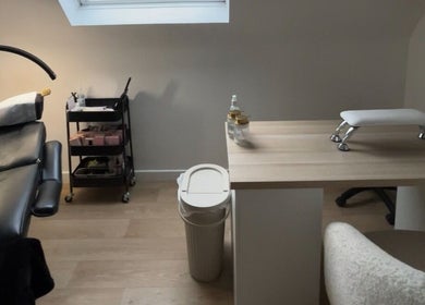 Modern treatment room at bylaceycathcart, Rosyth, Scotland, GB, featuring a nail table and massage bed.