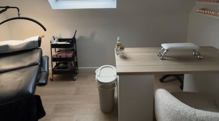 Modern treatment room at bylaceycathcart, Rosyth, Scotland, GB, featuring a nail table and massage bed.