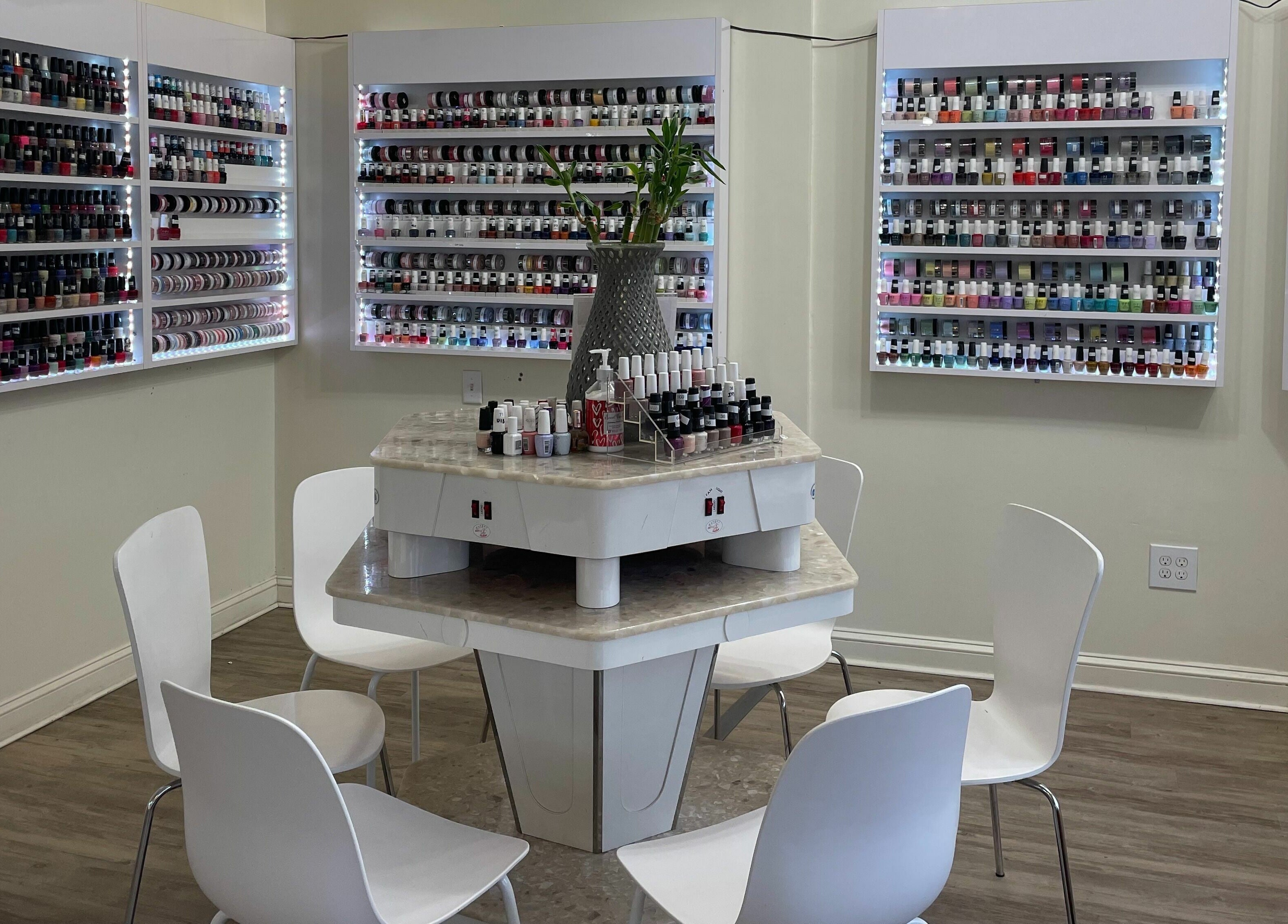 Nail polish display at Jade Nails & Spa, Inc., Wakefield, Massachusetts, US. Vibrant selection and cozy seating.