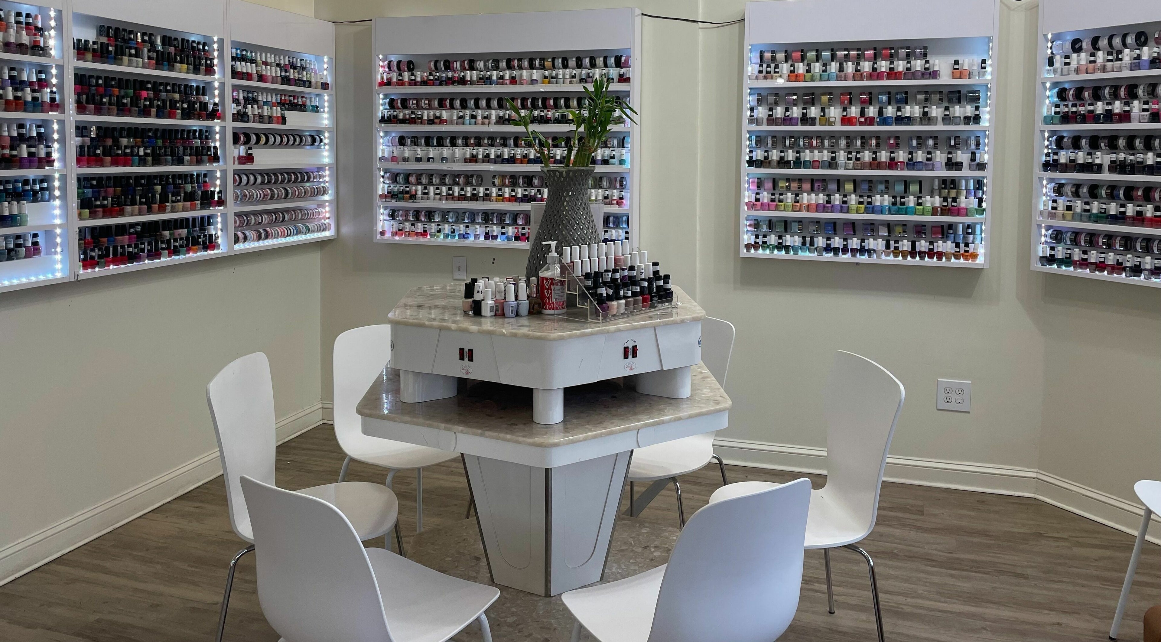 Nail polish display at Jade Nails & Spa, Inc., Wakefield, Massachusetts, US. Vibrant selection and cozy seating.