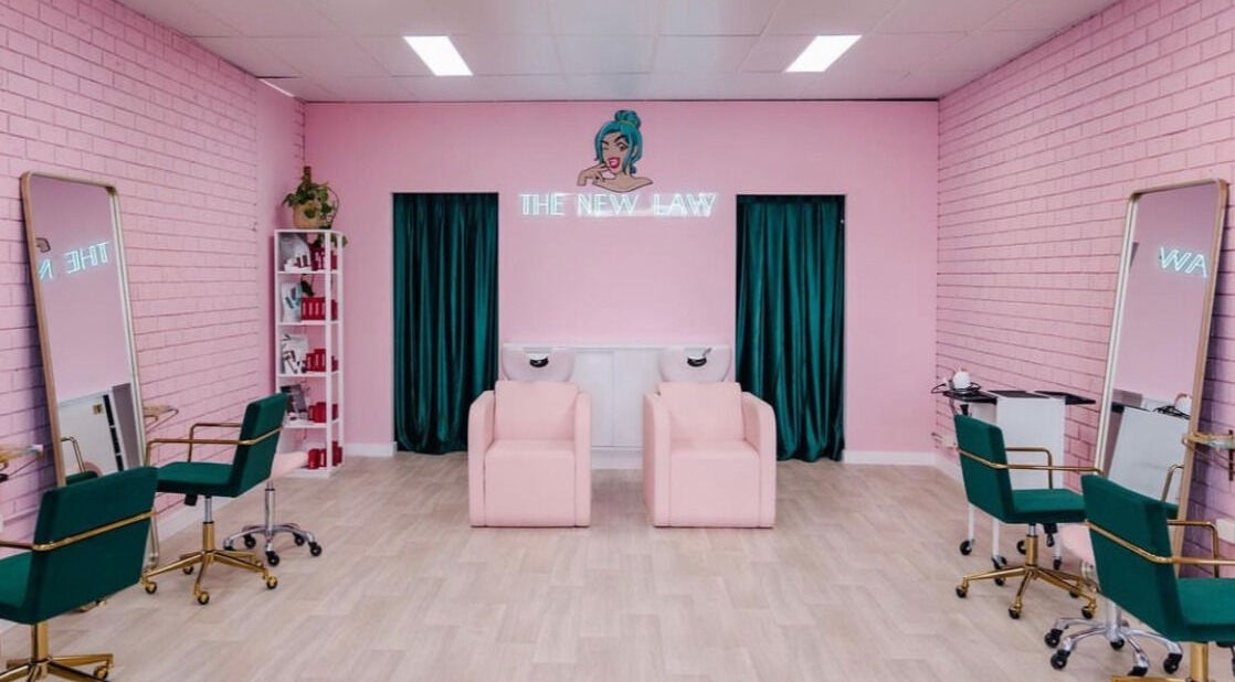 Stylish salon interior of The New Law in Wallsend, New South Wales, AU, featuring pink and green decor.