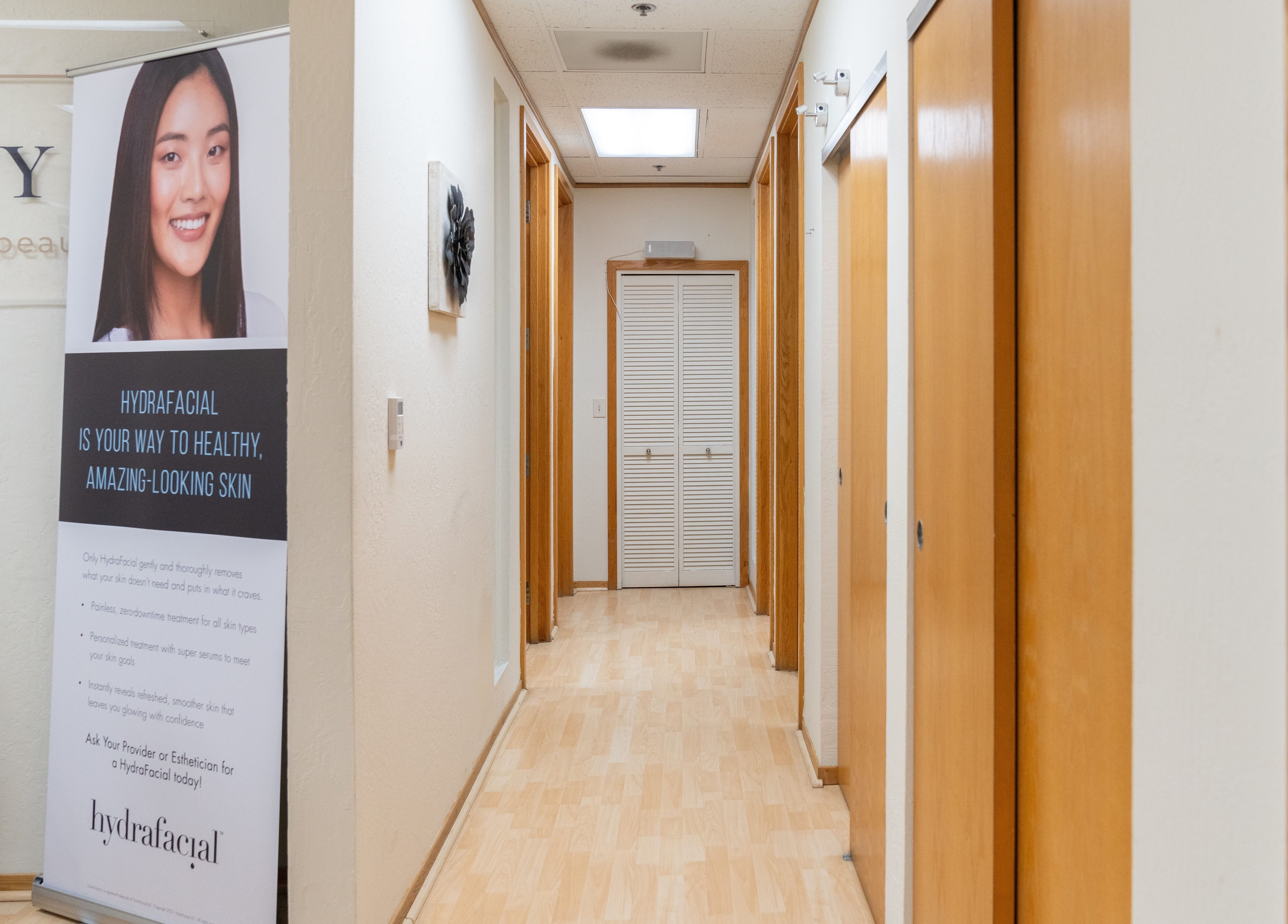 Bright, inviting hallway at Ibeauty PMU and Lashes, Fremont, California, showcasing Hydrafacial banner.