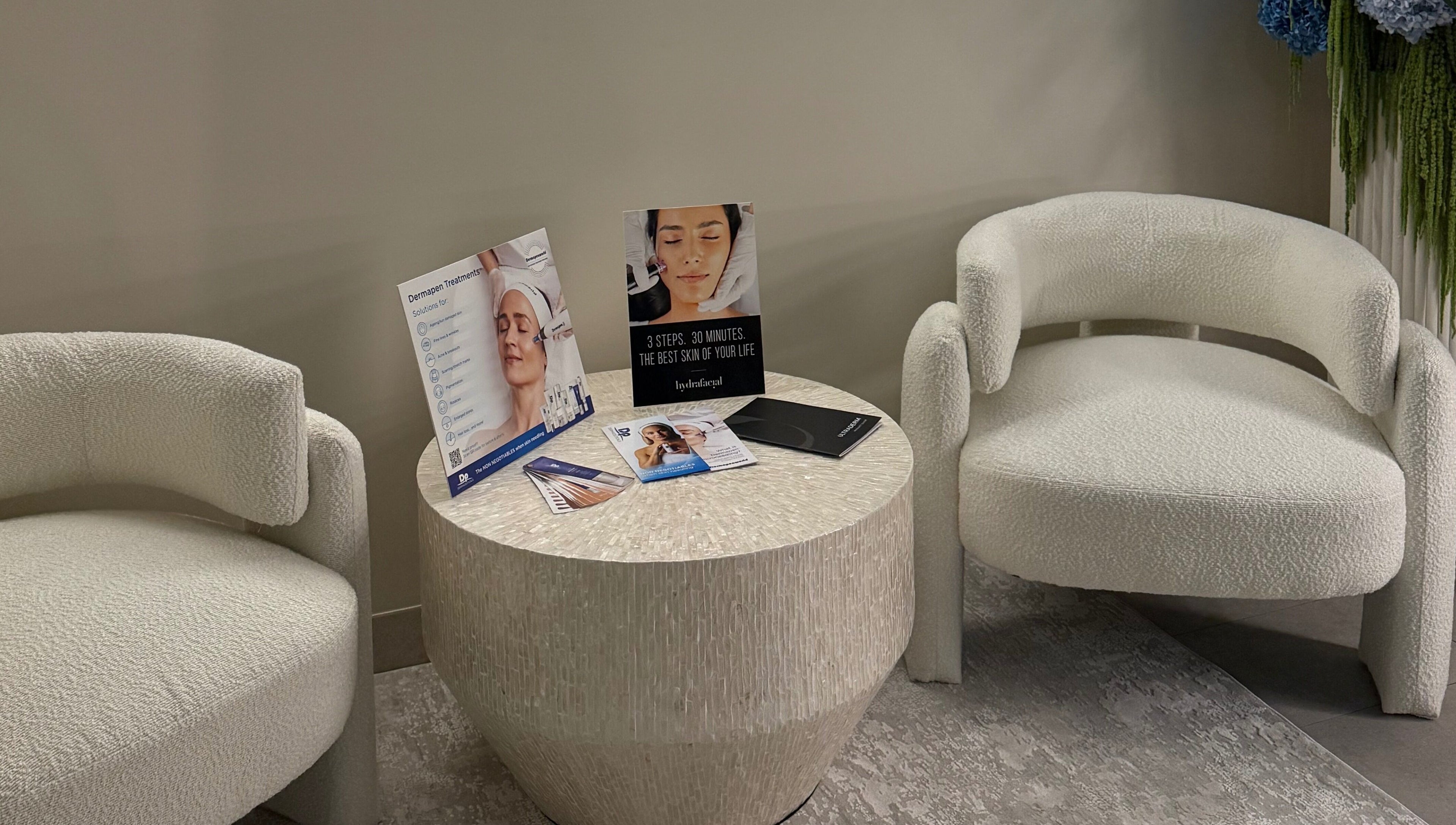 Seating area at Skin By T in Campsie, New South Wales, AU featuring cozy chairs and treatment brochures.