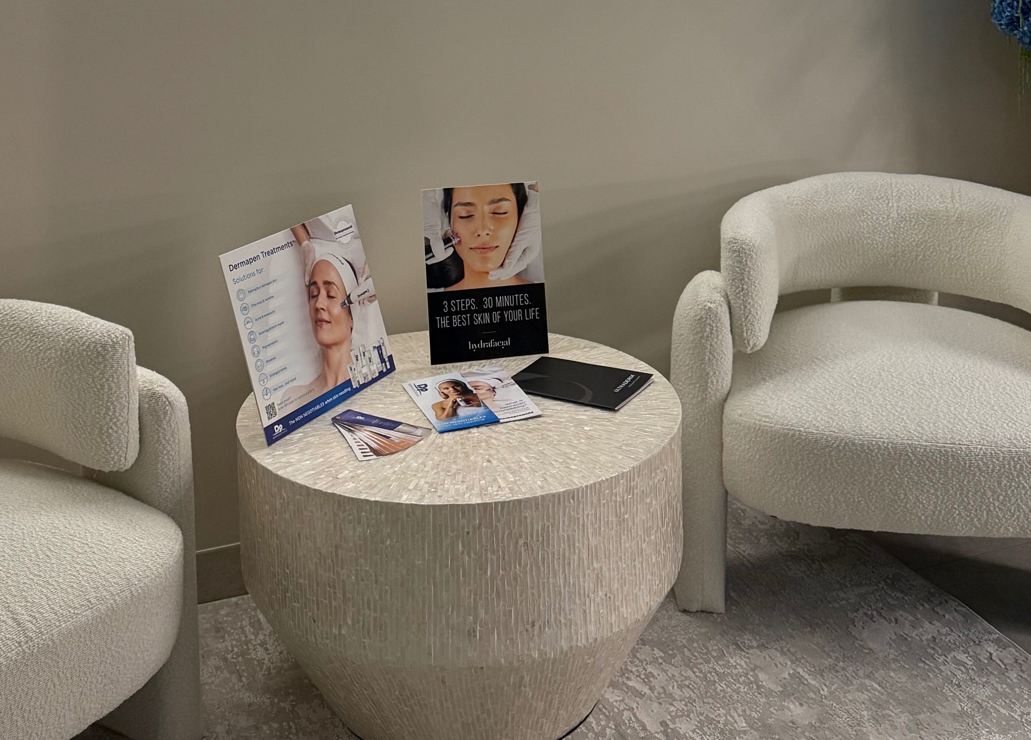 Seating area at Skin By T in Campsie, New South Wales, AU featuring cozy chairs and treatment brochures.