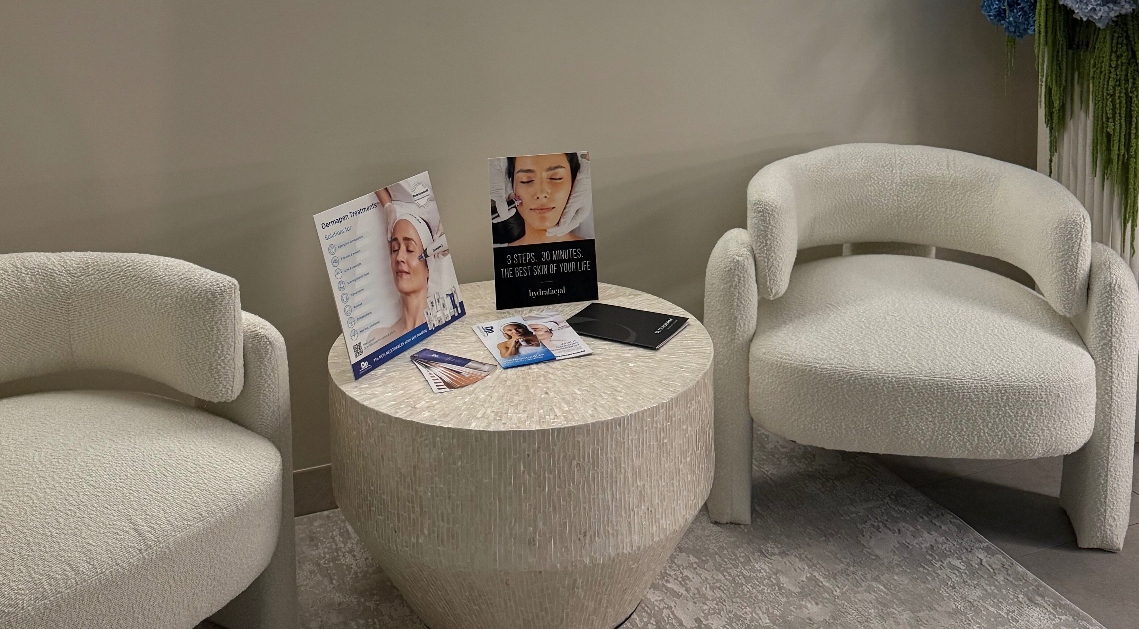 Seating area at Skin By T in Campsie, New South Wales, AU featuring cozy chairs and treatment brochures.