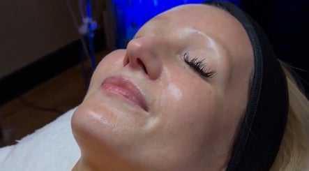 Relaxed woman receiving facial treatment at Signature Skin, Taverham, England, GB.