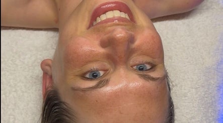 Smiling client enjoying facial at Signature Skin, Taverham, England, GB.