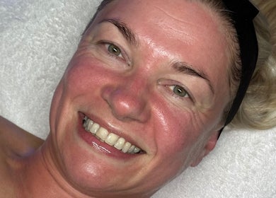 Client smiling after facial treatment at Signature Skin, Taverham, England, GB.