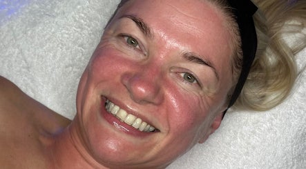 Client smiling after facial treatment at Signature Skin, Taverham, England, GB.
