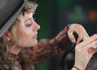 A stylist at Lissybeth Hair @ Hybrid (Formerly Koyo), Truro, England, GB, performing a precise haircut.