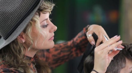 A stylist at Lissybeth Hair @ Hybrid (Formerly Koyo), Truro, England, GB, performing a precise haircut.