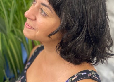 Client with short, wavy hair at Lissybeth Hair @ Hybrid, Truro, England, GB amidst green plants.