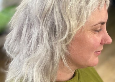 Elegant grey-haired woman at Lissybeth Hair @ Hybrid, Truro, England, GB, showcasing a stylish wavy haircut.