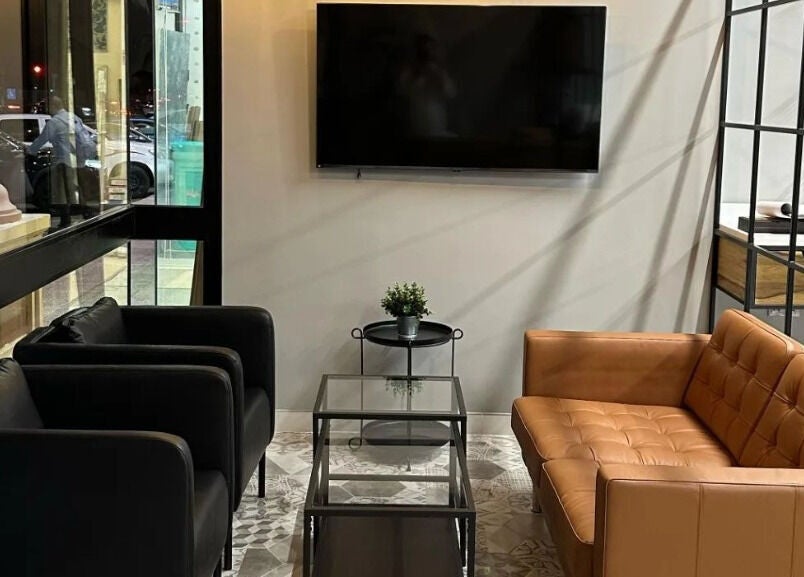 Modern lounge area at Yousef Afandi Barbershop - Al Sahafa, Riyadh, Riyadh Province, SA, with sleek seating and decor.