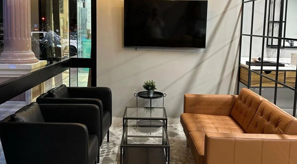 Modern lounge area at Yousef Afandi Barbershop - Al Sahafa, Riyadh, Riyadh Province, SA, with sleek seating and decor.