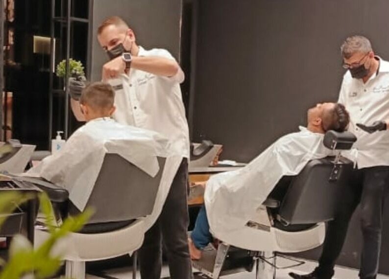 Professional barbers at work in Yousef Afandi Barbershop - Al Sahafa, Riyadh, Riyadh Province, SA.
