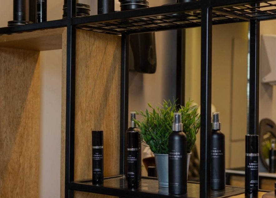 Stylish shelf with grooming products at Yousef Afandi Barbershop - Al Sahafa, Riyadh, Riyadh Province, SA.
